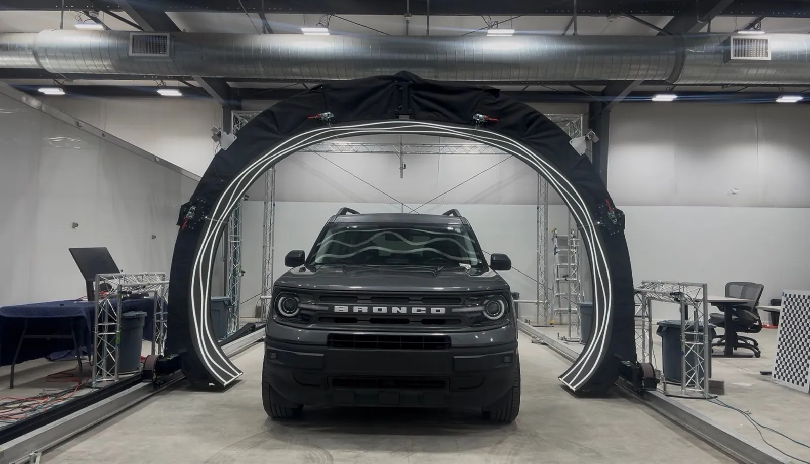 A vehicle passing under The Dent Barn's ARGUS 3D hail scanning arch